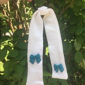 White hair tie with blue bow. Hair tie with tail